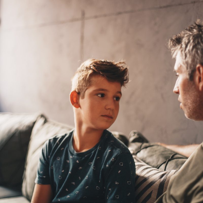 dad talking to teen son about the dangers of teenage binge drinking