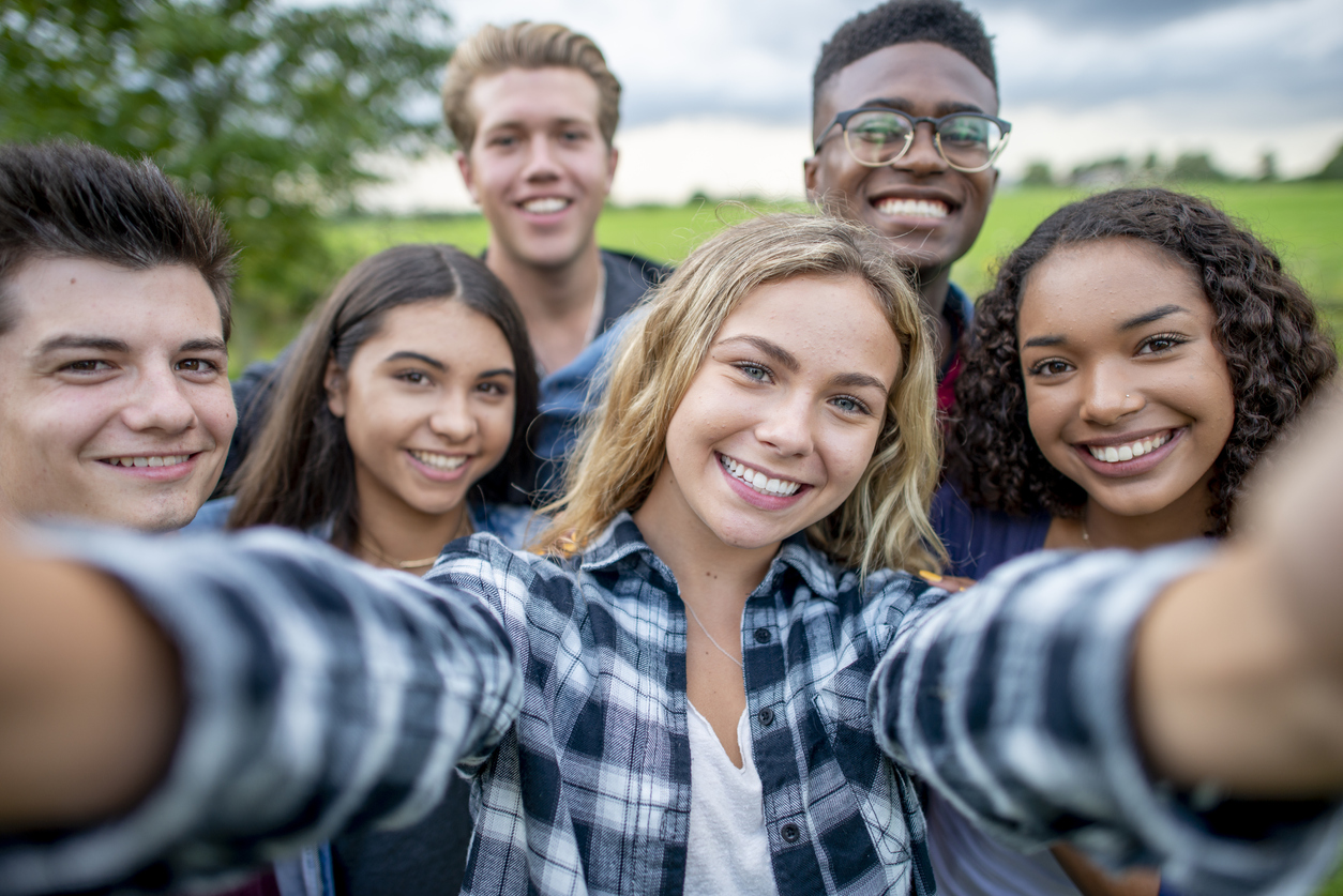 Group of teens smiling at Visions Teen Depression Treatment Center
