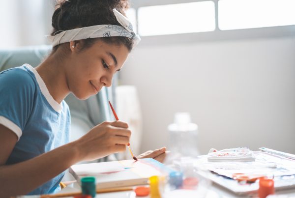 teen girl painting and exploring therapy activities for teen