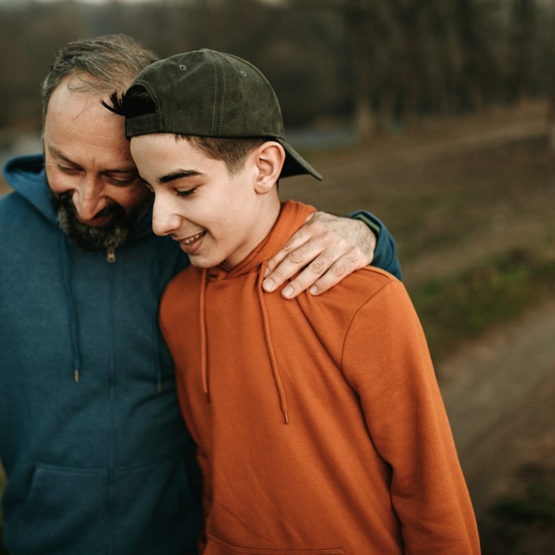 happy father and son after father learned how to help a teenager with mental health issues