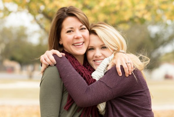 happy mother and daughter after talking about teen marijuana use