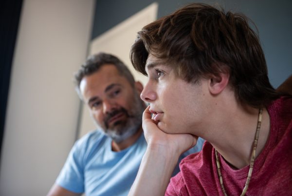 father looking at son for warning signs of adolescent depression