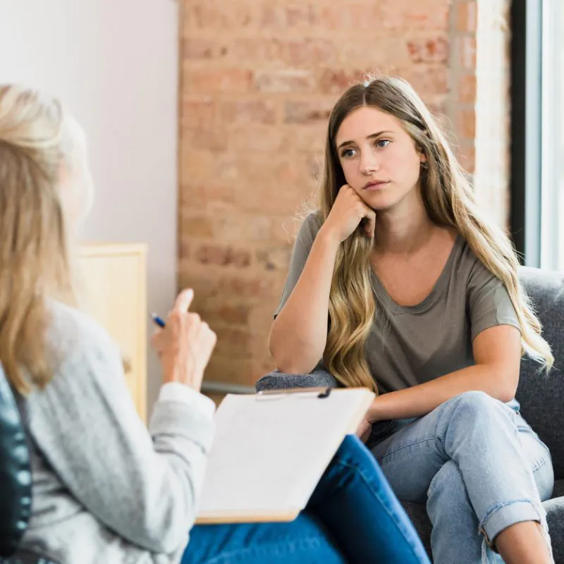 teen girl with counselor during clinical program at teen drug rehab