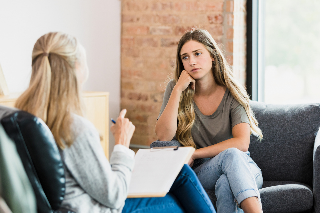 teen girl with counselor during clinical program at teen drug rehab