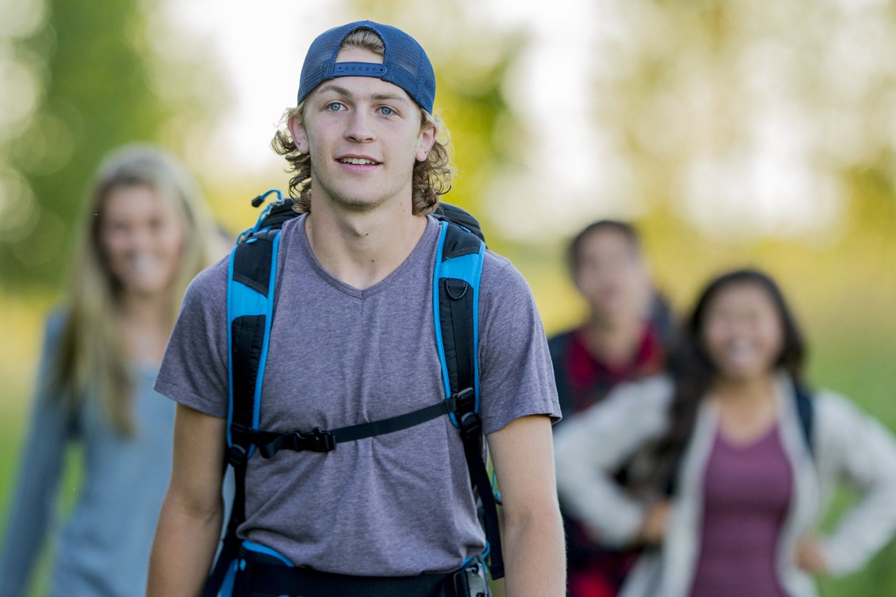 teen boy on hike during experiential program at teen drug rehab