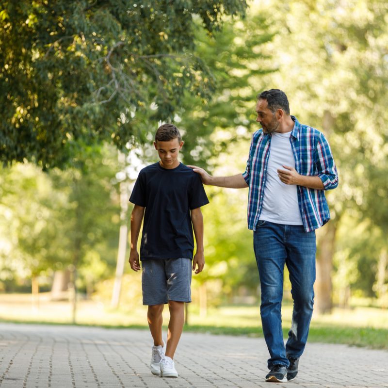 dad and son walking, dad wondering "how do I know if my teenager is depressed"