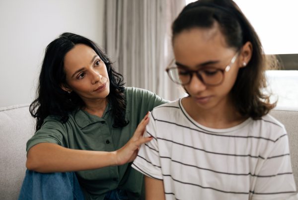 mother comforting teen daughter after learning what not to say to a depressed teenager