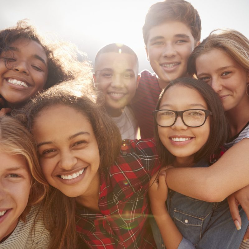 group of happy teens together during teen residential treatment for depression
