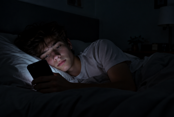Teen talking to an AI chatbot on a phone late at night