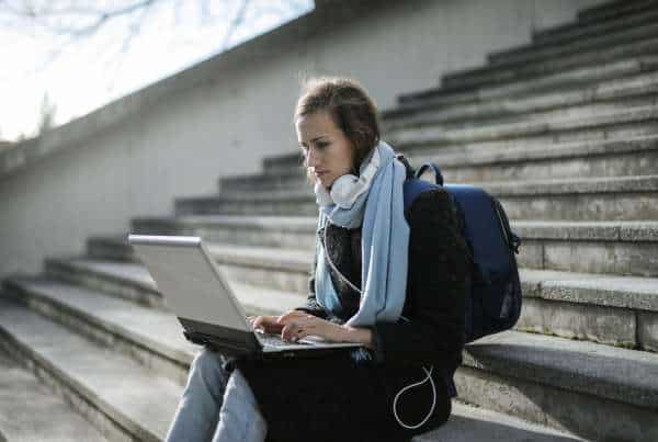 Adolescent using teletherapy for teens on a laptop